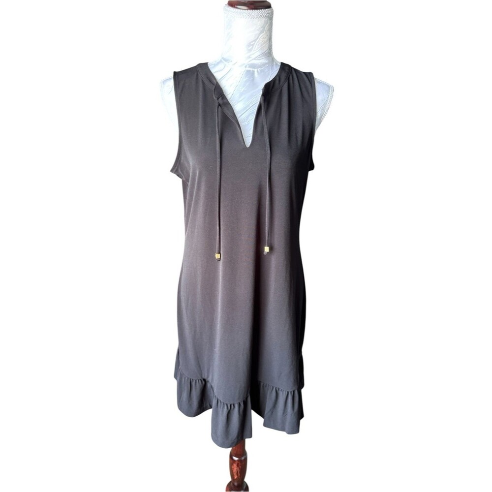 Michael Kors sleeveless shift dress featuring a ruffled hem and a tie front